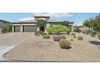 Beautiful home with 3-car garage, mature landscaping, and a paved driveway at 248 N Milan St, Henderson, NV 89015