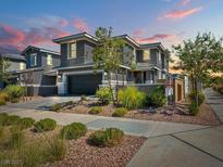 Two-story home with gray exterior, landscaped yard, and two-car garage at 800 Cadence View Way, Henderson, NV 89011