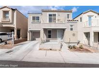 Two-story home features a small front porch, balcony, attached garage, and desert landscaping at 9132 Pearl Cotton Ave, Las Vegas, NV 89149