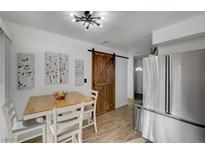 Bright kitchen features stainless steel appliances and a rustic sliding barn door at 155 E Van Wagenen St, Henderson, NV 89015