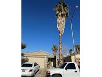 Single-story home with a two-car garage and mature landscaping at 2408 Shady Hill Ave, Las Vegas, NV 89106