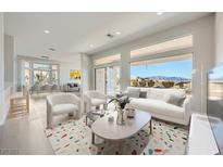 Bright, open-concept living room features large windows with mountain views and stylish decor at 2904 Bow Bridge Dr, Las Vegas, NV 89134