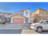 Two-story house with a pink garage door and a paved driveway at 7053 Solana Ridge Dr, North Las Vegas, NV 89084