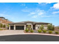 Single-story home with a three-car garage and landscaped front yard at 12456 Edinburgh Cask Ave, Las Vegas, NV 89138