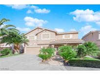 Two-story house with landscaped front yard, driveway, and attached garage at 1326 Summer Dawn Ave, Henderson, NV 89014