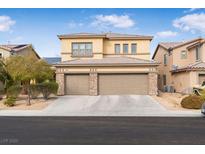 Two-story house with a three-car garage and landscaped front yard at 1932 Barrow Glen Ct, North Las Vegas, NV 89084