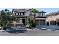 Two-story house with a three-car garage, fountain, and landscaping at 3115 Azure Bay St, Las Vegas, NV 89117