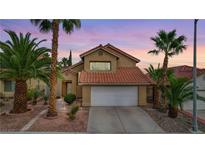 Two-story house with Spanish tile roof, landscaped yard, and two-car garage at 3320 Haven Beach Way, Las Vegas, NV 89117