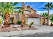 Charming two-story home featuring a well-manicured front yard with mature palm trees and a red tile roof at 3320 Haven Beach Way, Las Vegas, NV 89117