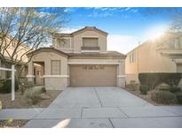 Two-story house with tan exterior, landscaping, and a two-car garage at 3817 Bella Legato Ave, North Las Vegas, NV 89081