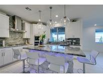 Modern kitchen with granite counters, stainless steel appliances, and an island at 6942 Alexandrite Peak St, Las Vegas, NV 89148