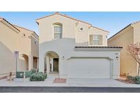 Two story house with a two car garage and landscaped front yard at 7564 Daniel Boone Ct, Las Vegas, NV 89166