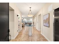 Elegant entryway with tile floors and views into the living area at 9121 Las Manaitas Ave # 401, Las Vegas, NV 89144