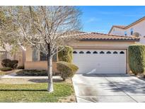 One-story house with tan walls, white garage door, and landscaping at 9272 Cantana St, Las Vegas, NV 89123