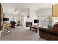 Bright living room features a fireplace, dining area, and sliding glass doors to the outside patio at 5201 S Torrey Pines Dr # 1172, Las Vegas, NV 89118