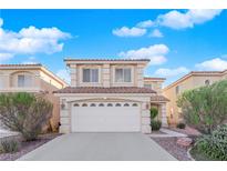 Two-story house with a white garage door and landscaped yard at 7640 Ribbon Garland Ct, Las Vegas, NV 89139