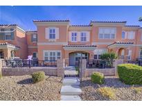 Two-story townhome with front patio and landscaped yard at 2120 Waterlily View St, Henderson, NV 89044