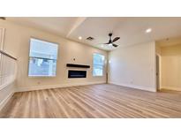 Bright living room featuring a fireplace and hardwood floors at 10173 Grants Arbor Rd, Las Vegas, NV 89183