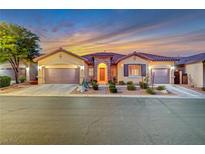 Beautiful desert home with a 3-car garage and landscaped yard at 10290 Hawks Wing St, Las Vegas, NV 89178