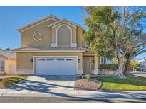 Two-story house with a landscaped yard and attached two-car garage at 2525 Huber Heights Dr, Las Vegas, NV 89128