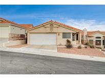 Single-story house with a tan stucco exterior, red tile roof, and a two-car garage at 408 Matecumbe Way, Boulder City, NV 89005