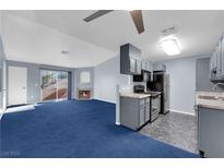 Open kitchen with gray cabinets and modern appliances at 4730 E Craig Rd # 2158, Las Vegas, NV 89115