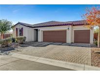 Single-story house with three-car garage and brick driveway at 5805 Vibrant Violet Ct, Las Vegas, NV 89130