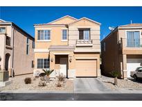 Two-story house with beige exterior, attached garage, and landscaping at 6074 Lazarro Ct, Las Vegas, NV 89139