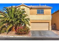 Two-story house with beige exterior, palm tree, and attached garage at 6228 Wood Stork Ave, Las Vegas, NV 89122