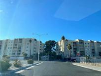 Condo building with parking and gated entrance at 730 S Royal Crest Cir # 445, Las Vegas, NV 89169