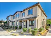 Two-story townhome with attractive landscaping and two-car garage at 7336 N Decatur Blvd # 2, Las Vegas, NV 89131