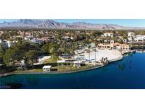 Aerial view of a community with lake, clubhouse, and lush landscaping at 7608 Sea Wind Dr, Las Vegas, NV 89128