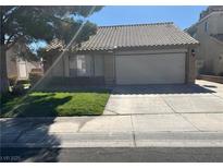 Single-story home with attached garage and well-maintained lawn at , Henderson, NV 89014