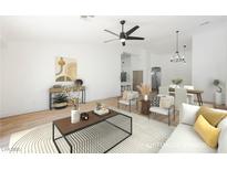 Virtually staged living room features a neutral color palette, modern furniture, and hardwood floors at 10229 Birch Bluff Ln, Las Vegas, NV 89145