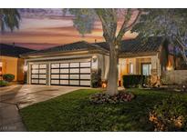 Stunning curb appeal! This single-story home features a modern garage door and well-manicured lawn at 140 Cora Hills Ct, Las Vegas, NV 89148