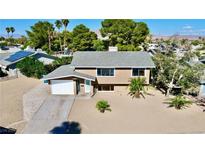 Tan two-story house with a landscaped yard and solar panels at 3950 Ventura Way, Las Vegas, NV 89121