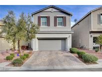 Two-story house with gray siding, shutters, and a paved driveway at 7960 Brookside Falls Ct, Las Vegas, NV 89166