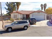 Single-story house with red tile roof, attached garage, and driveway at 8072 Hackberry Dr, Las Vegas, NV 89123