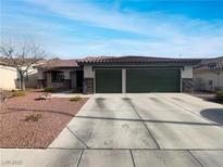 Single-story home with a two-car garage and well-manicured landscaping at 866 Austin Peak Ct, Las Vegas, NV 89110