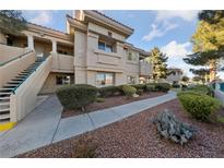 Inviting condo building with landscaped grounds and walkway at 1500 Jenny Linn Dr # 1500, Henderson, NV 89014