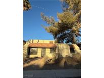 Spanish-style home with a red tile roof and mature landscaping at 2112 Venus Ave # A, North Las Vegas, NV 89030