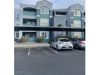 Two-story building with covered parking and landscaping at 6955 N Durango Dr # 1077, Las Vegas, NV 89149