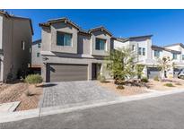 Charming two-story home with a two-car garage and brick driveway. Landscaped front yard at 10467 Joaquin Fire St, Las Vegas, NV 89141