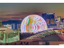 Aerial view of illuminated cityscape at night, featuring a unique dome-shaped structure at 2777 Paradise Rd # 2001, Las Vegas, NV 89109
