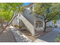 Exterior view of a light-colored building with stairs and landscaping at 5650 E Sahara Ave # 1012, Las Vegas, NV 89142