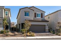 Two-story house with brown garage door and landscaping at 6642 Evander St, North Las Vegas, NV 89086