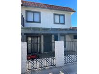 Two-story stucco building with covered patio and attached garage at 1009 Willow Tree Dr # C, Las Vegas, NV 89128
