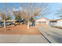 Ranch-style home with mature trees and a large front yard at 1801 Ginger Tree Ln, Las Vegas, NV 89104