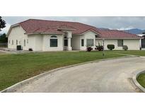 A charming single-story home with stucco exterior, tile roof, and well-manicured lawn at 390 China St, Pahrump, NV 89048