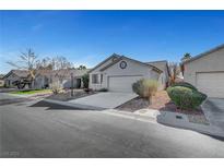 Charming single-story home with a well-maintained front yard and attached two-car garage at 5919 Pavilion Lakes Ave, Las Vegas, NV 89122